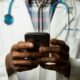 Doctor using an app on a smartphone device as healthcare regulator MHRA is fast-tracking new AI tools that promise to dramatically improve patient care.