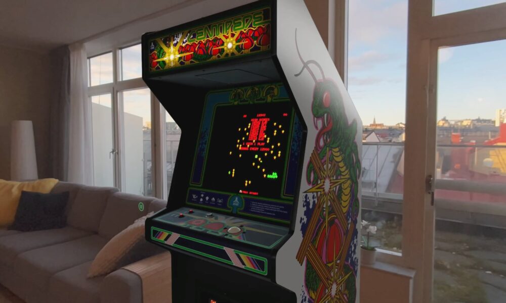A digital recreation of the classic Atari Centipede arcade cabinet as seen in the 'Retrocade' app on Apple Vision Pro, featuring authentic side-panel artwork and a glowing game screen in a spatial 3D environment.