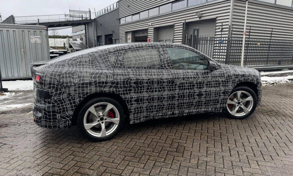 BMW iX4 prototype with camouflage reveals sloping roofline and rakish coupe proportions