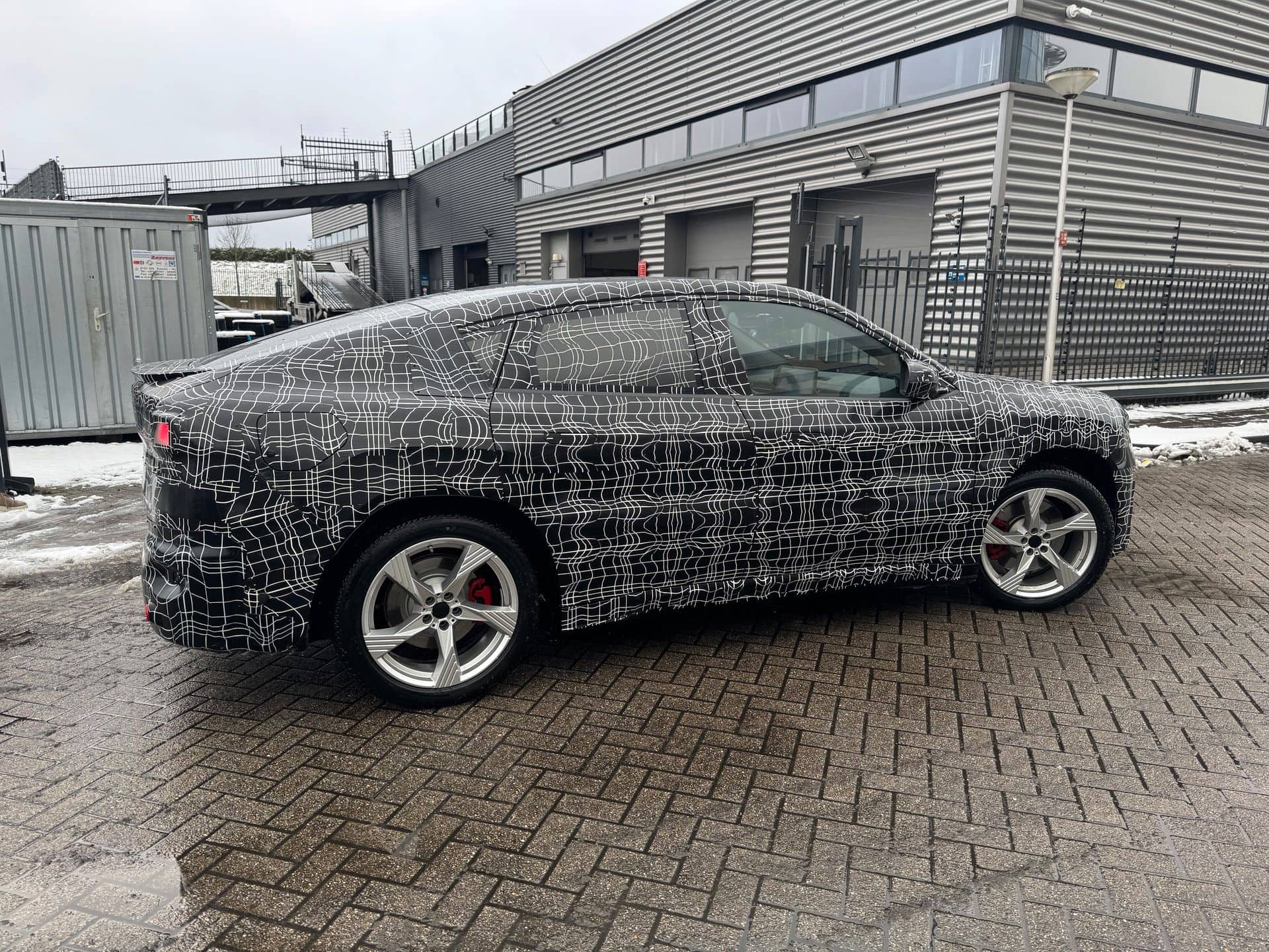 BMW iX4 prototype with camouflage reveals sloping roofline and rakish coupe proportions
