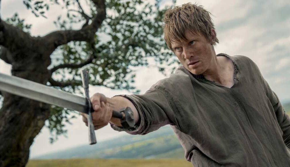 Dunk holding a sword aloft