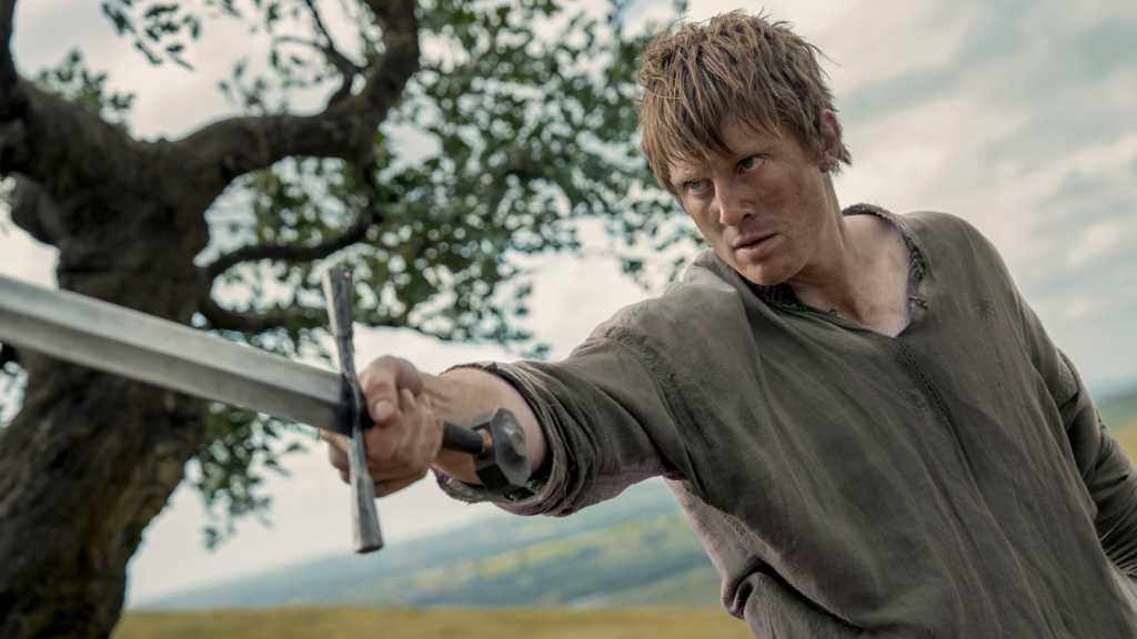 Dunk holding a sword aloft