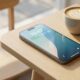 A modern iPhone resting on a wooden table in a brightly lit cafe, symbolizing all-day battery life.