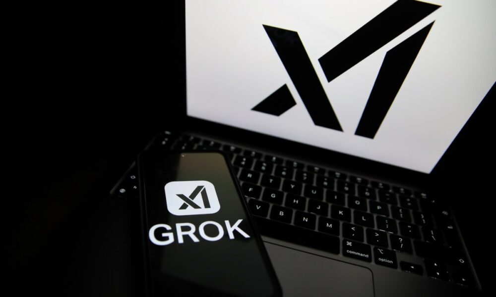 The Grok logo appears on a phone and the xAI logo is displayed on a laptop.