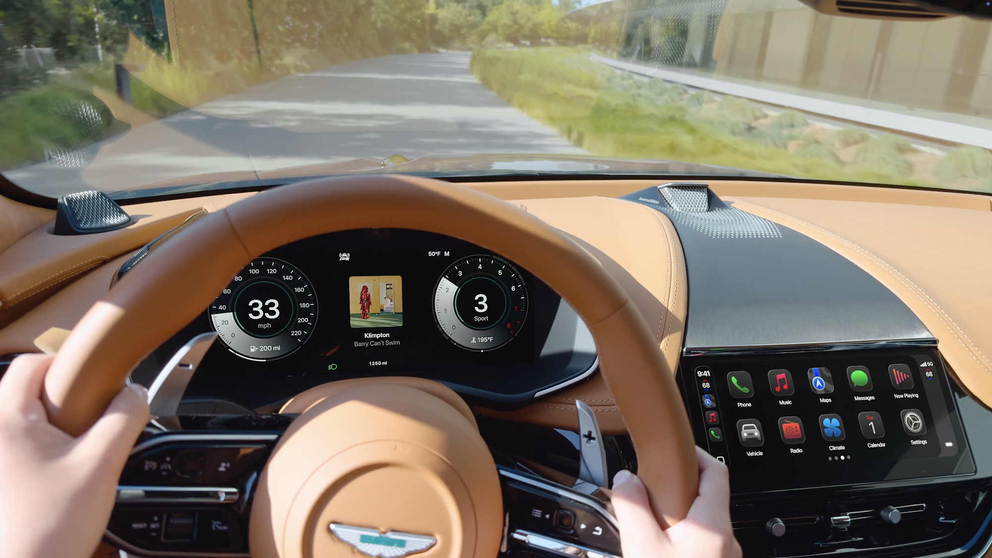 A professional press photo of the Apple CarPlay Ultra interface inside an Aston Martin. The dashboard features two distinct digital displays: a 10.25-inch central touchscreen showing a grid of icons including Phone, Music, Messages, and new vehicle-integrated apps for Radio and Climate. Behind the steering wheel, the driver’s instrument cluster is fully overtaken by CarPlay, displaying traditional-style Aston Martin circular dials for speed and RPM with a live Apple Maps navigation view in the center. The cabin features premium silver switchgear and leather-stitched trim.