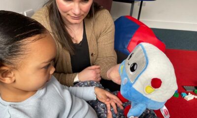 Mya, age 3, and her mum, Vicky, playing with the AI toy, Gabbo, during an observation at the University of Cambridge’s Faculty of Education.