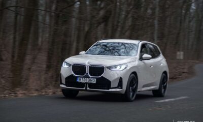 2026 BMW X3 xDrive30e plug-in hybrid SUV driving on a winding road