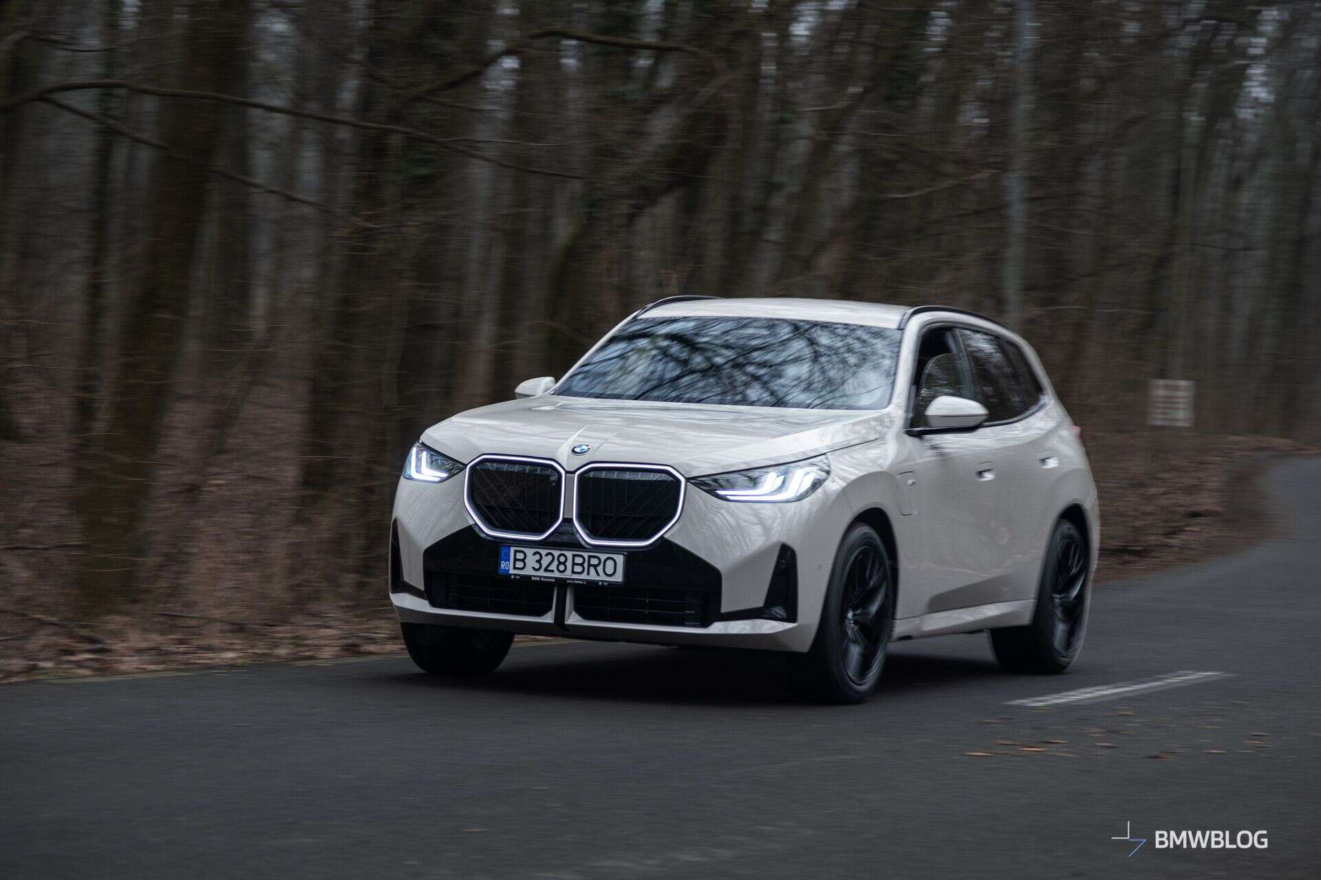 2026 BMW X3 xDrive30e plug-in hybrid SUV driving on a winding road
