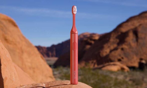 Suri 2.0 Canyon Sunrise electric toothbrush standing on a rock