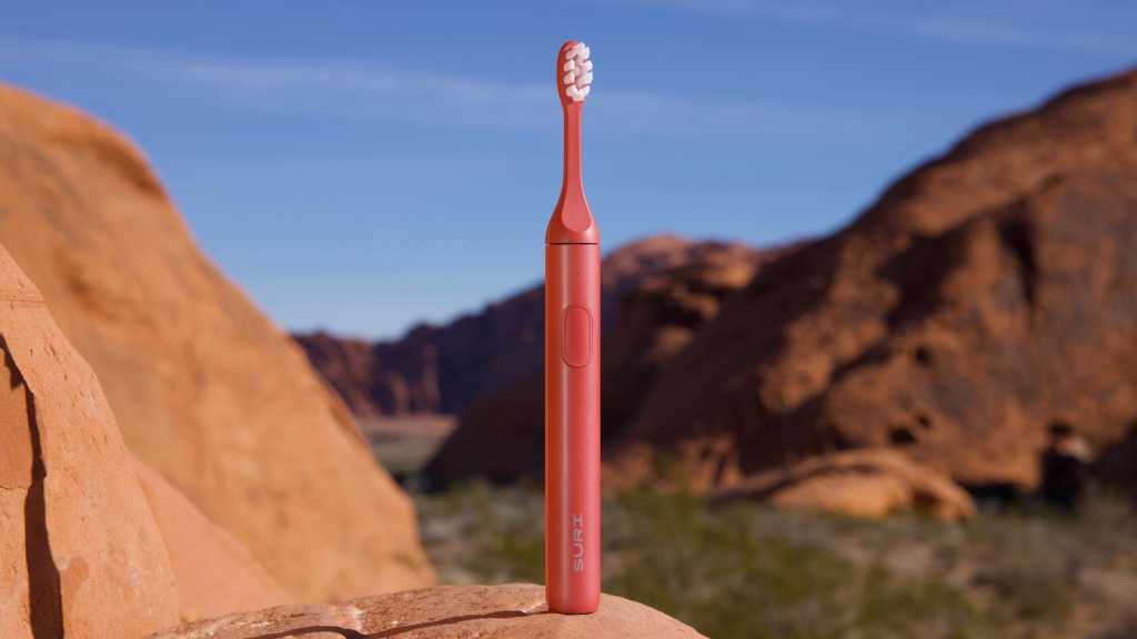 Suri 2.0 Canyon Sunrise electric toothbrush standing on a rock