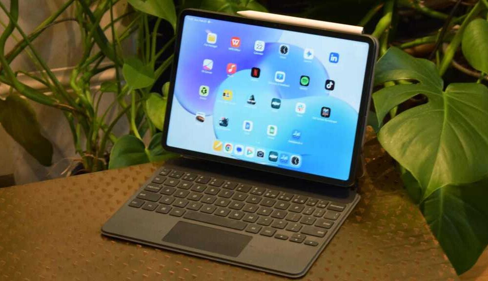 The Xiaomi Pad 8 in its Smart Keyboard, on a table by some plants.