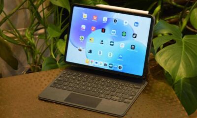 The Xiaomi Pad 8 in its Smart Keyboard, on a table by some plants.