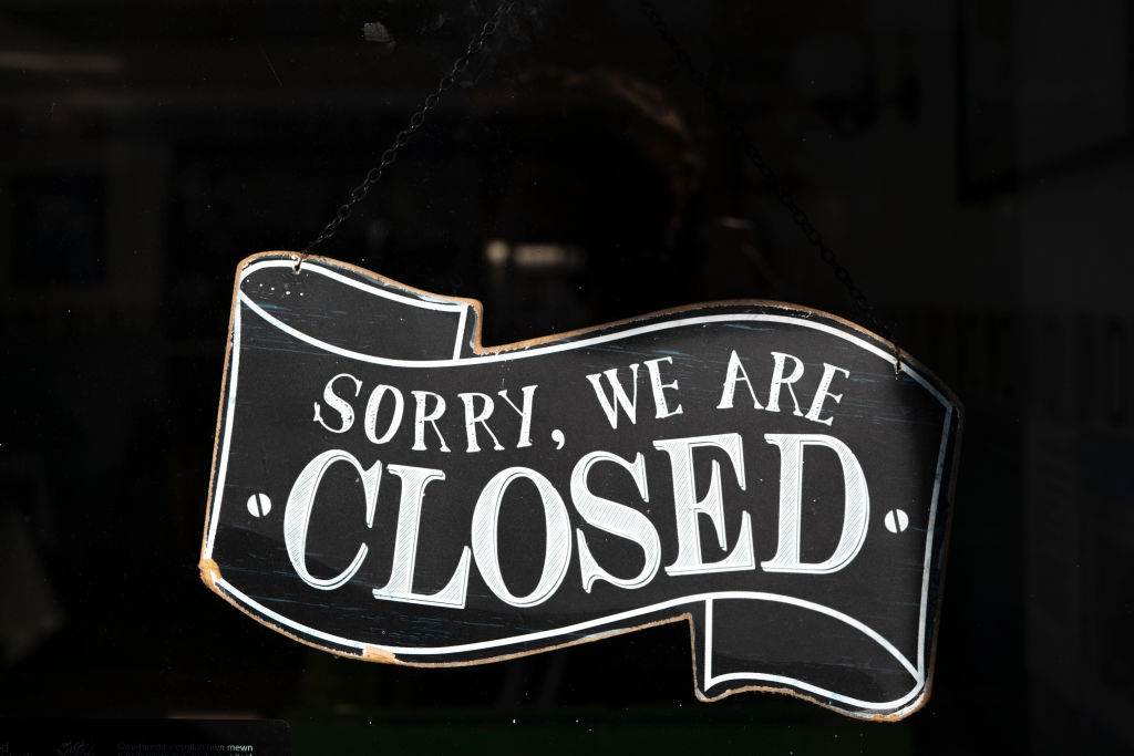 A closed sign in the window of a small business