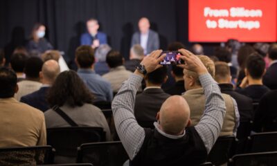 An attendee at a StrictlyVC 2025 event taking a photograph