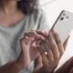 woman typing on iPhone