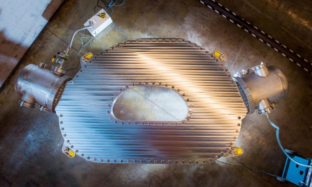 A large HTS magnet sits on the floor of a warehouse.