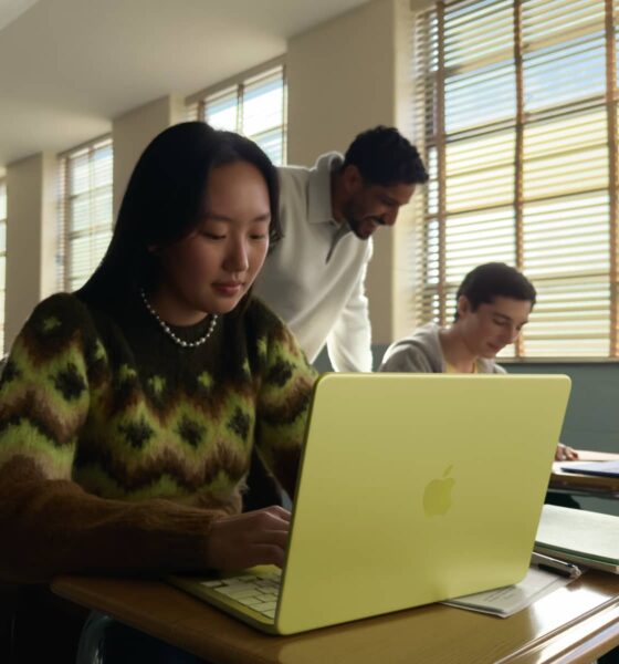 A student working in a bright classroom on a Citrus-colored MacBook Neo, showcasing Apple's most affordable laptop.