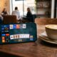An iPhone showing a vibrant card game on an iPhone 17 Pro in a modern coffee shop setting.