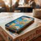 An iPhone running the digital Ticket to Ride game rests directly upon an unopened physical Ticket to Ride board game box on a warm wooden table in a busy cafe, illustrating the blend of modern mobile gaming and traditional tabletop play.