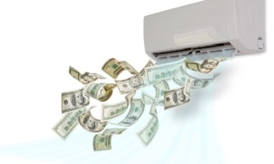 dollar bills flying out of an air conditioning unit