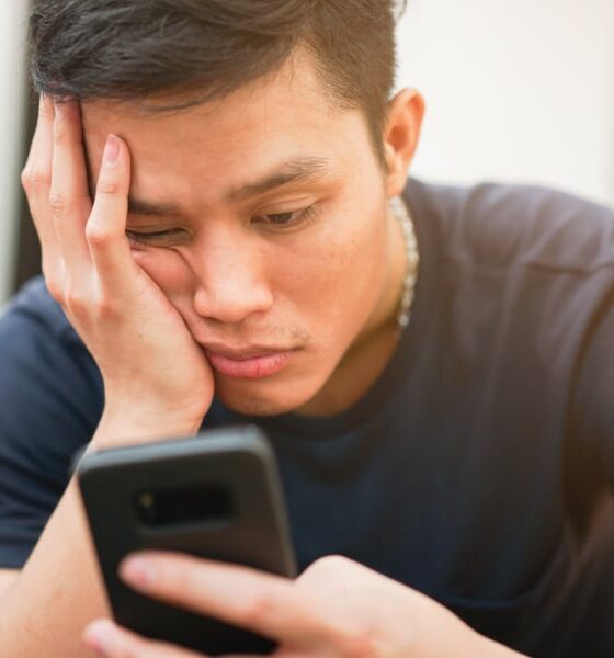man frustrated by slow smartphone