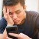 man frustrated by slow smartphone