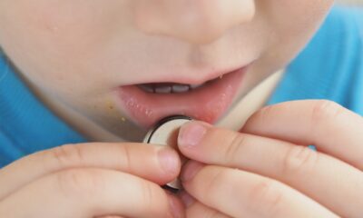 close up coin battery in the child's hands danger of swallowing