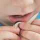 close up coin battery in the child's hands danger of swallowing