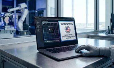 A 2026 MacBook Pro displayed inside a high-tech Intel fabrication facility showing a 'Made in the USA' certification on its screen.