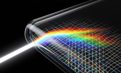 A conceptual close-up conceptual abstract image showing light refracting and dispersing into a rainbow spectrum as it enters the complex quad-curved glass corner of a futuristic display, visualizing potential edge distortion.