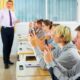 Teen students using social media on phones on lesson