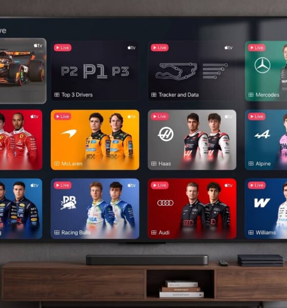 A flat-screen TV displaying the F1 "Race Day Live" multiview feed on the Apple TV app, positioned above a media console in a modern, well-lit living room setting.