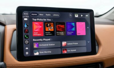 Vehicle infotainment display showing CarPlay Apple Music screen in iOS 27.