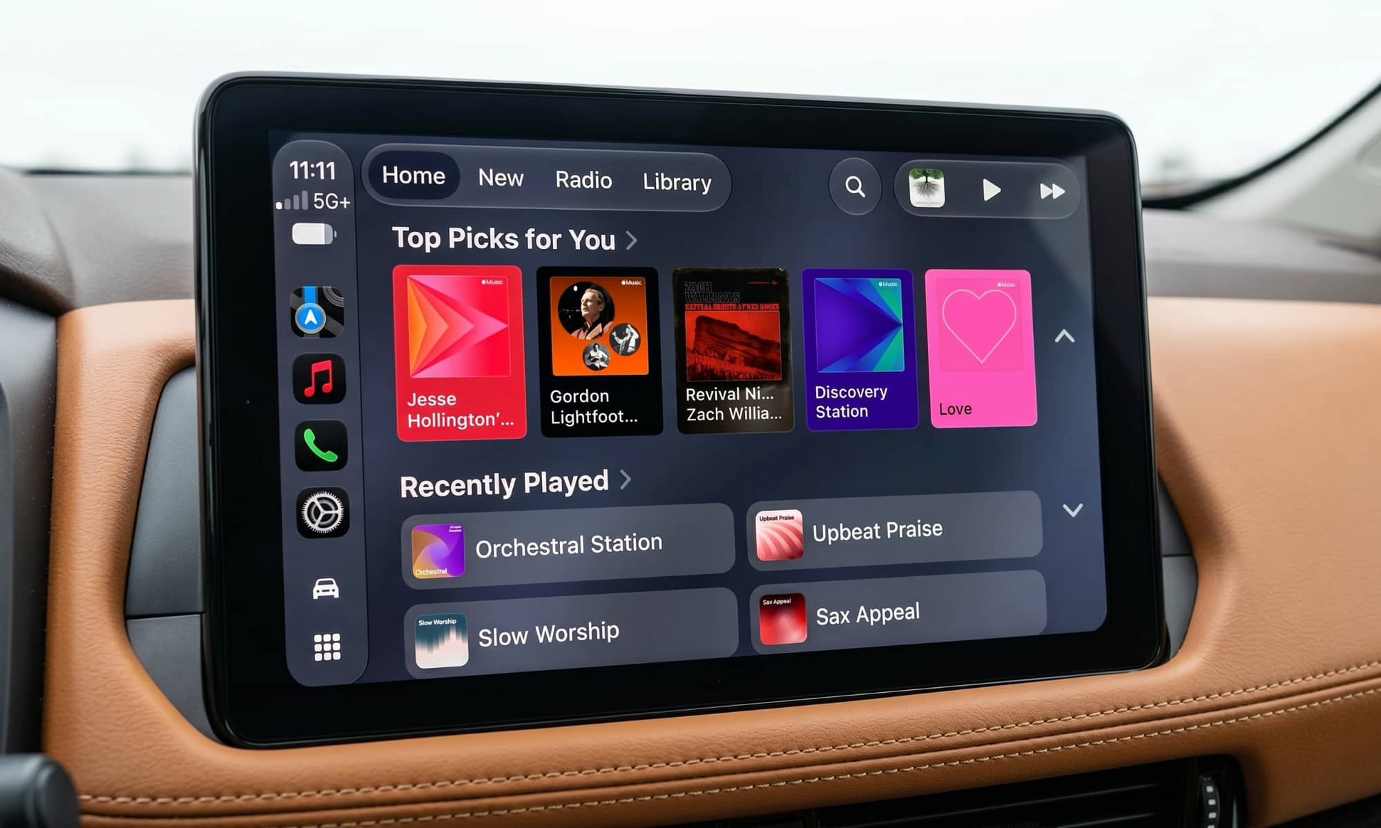 Vehicle infotainment display showing CarPlay Apple Music screen in iOS 27.