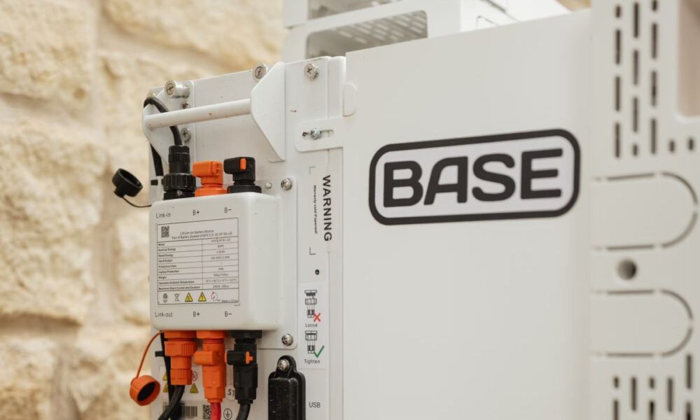 A Base Power battery sits next to a home.