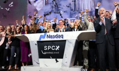 Bret Johnsen (C), SpaceX Chief Financial Officer, and Gwynne Shotwell (center R), SpaceX President and Chief Operating Officer, celebrate as they ring the opening bell at the Nasdaq MarketSite to celebrate the launch of SpaceX’s initial public offering (IPO) in New York on June 12, 2026.