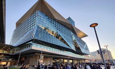 Sydney modern skyline viewed at Darling Harbor. People walking on the pedestrian zone in central Sydney.