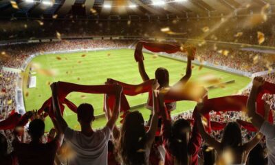 Fans holding up their flags at a football stadium