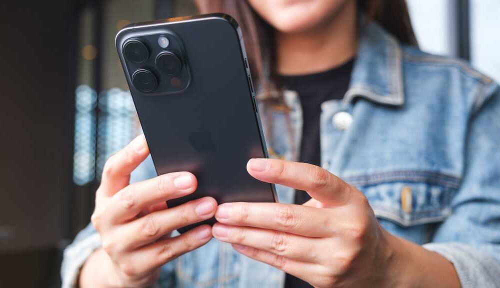 Woman with smartphone in hands, iPhone