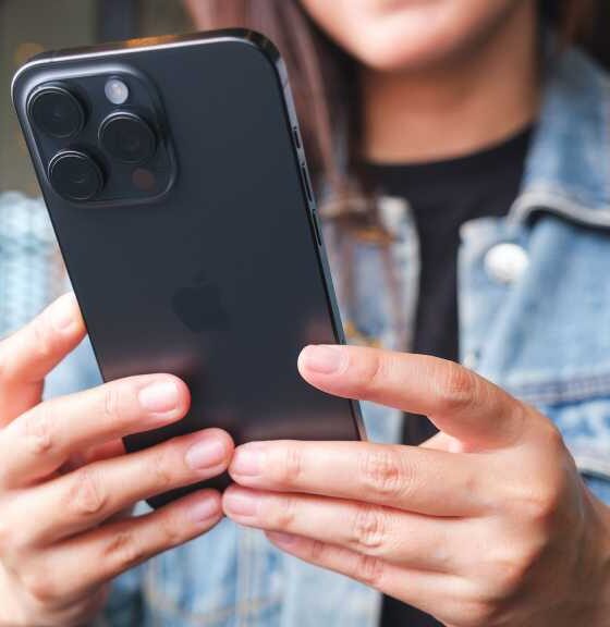 Woman with smartphone in hands, iPhone