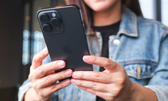 Woman with smartphone in hands, iPhone