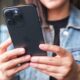 Woman with smartphone in hands, iPhone