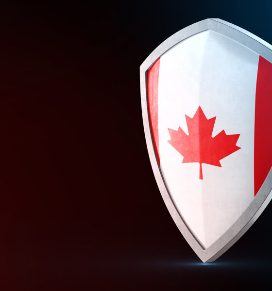 Canada is leveraging its abundant resources and innovation in advanced materials to address emerging threats and geopolitical challenges Protection shield and safeguard concept. Shiny steel armor painted as Canada national flag. Safety badge. Security label and Defense sign. Force and strong symbol. 3D rendering