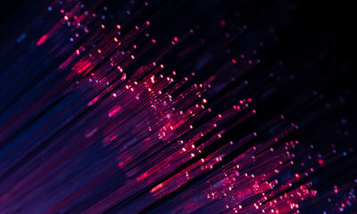 Deployed underground: How Lisbon’s LUMIRing is emerging as a globally recognised testbed for multicore fibre technology Abstract purple and blue fiber optic lights creating a vibrant digital data flow concept, ideal for modern technology and futuristic communication visuals.