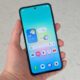 A hand holding the Samsung Galaxy A27 with its screen on