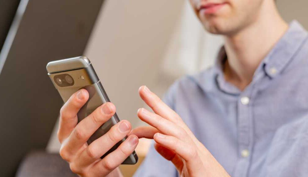 A man using the Google Pixel 8 smartphone