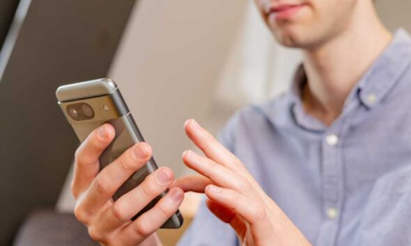 A man using the Google Pixel 8 smartphone