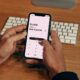person managing money on iPhone