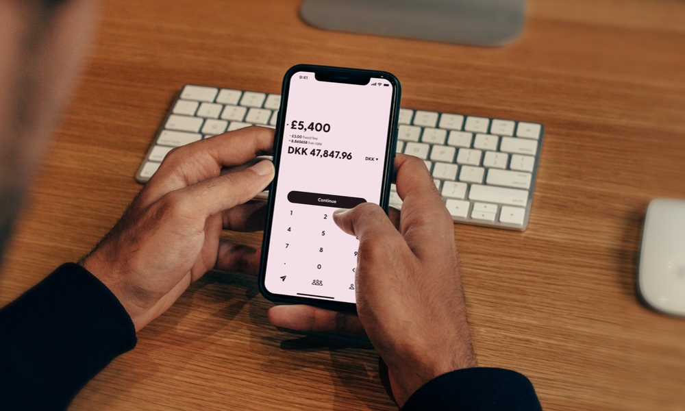 person managing money on iPhone