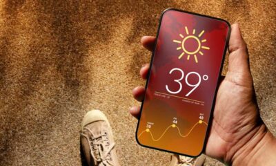 Someone using a smartphone displaying hot weather